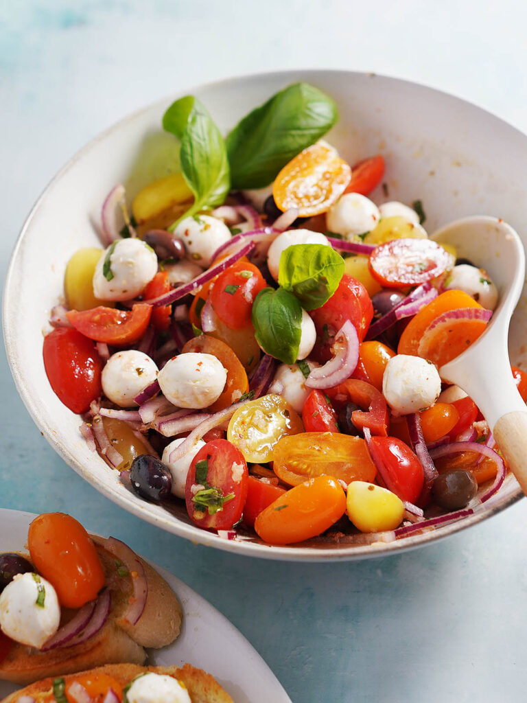 A large bowl with the tomato & mozzarella salad.
