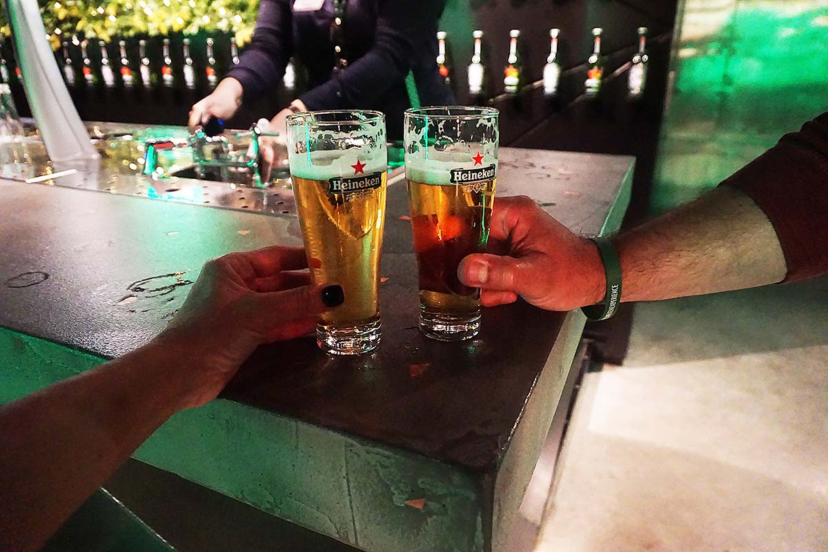 Two hands cheering beer glass.