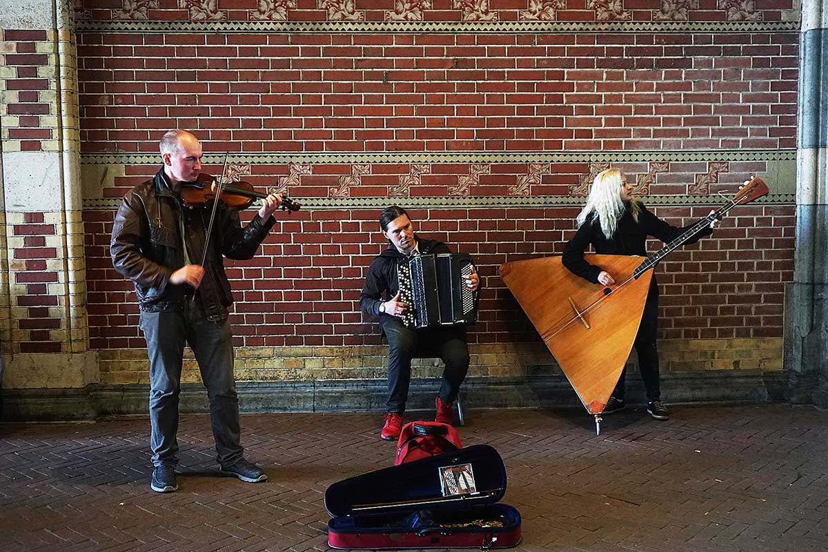 Three musicians playing on the street.