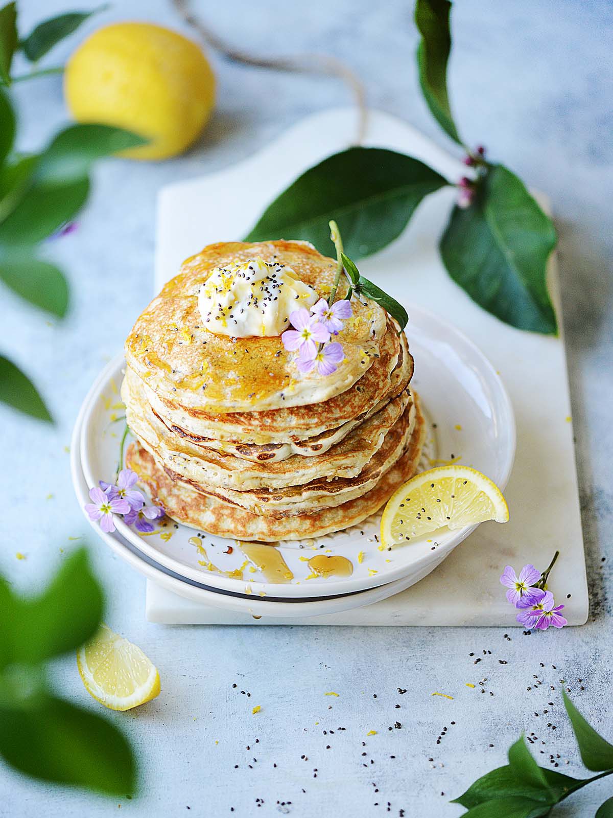 A stack of pancakes on a white plate.