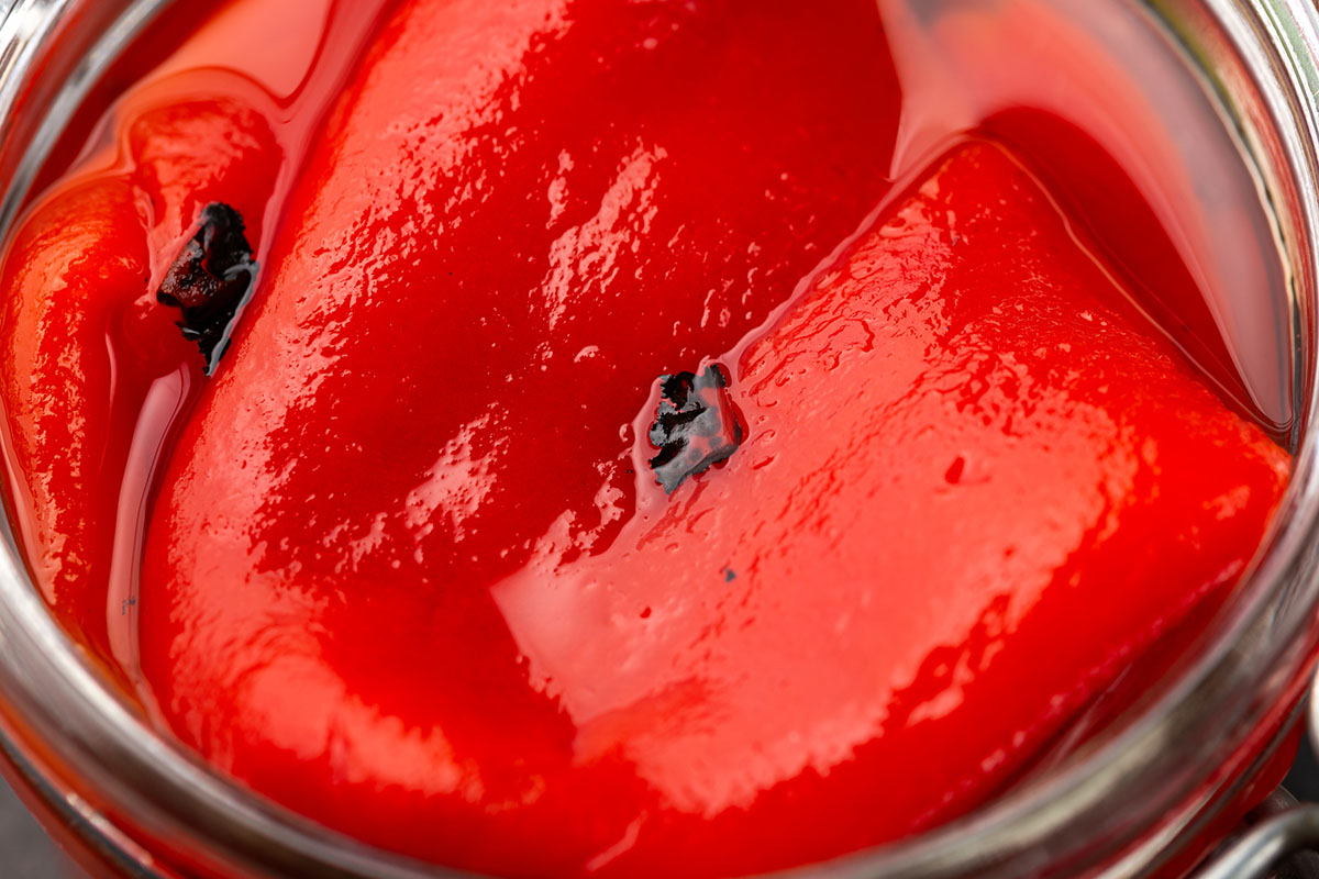 Baked, Roasted Red pepper on grill in glass jar