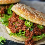 Two sloppy joes sandwiches made with sesame buns.