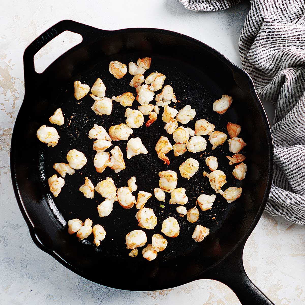 Sauteing shrimp on a skillet.