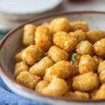 Air fryer Tater tots in a white bowl.
