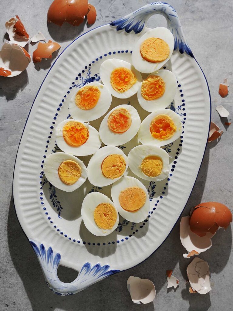 Boiled eggs sliced in half placed on a pretty plate.